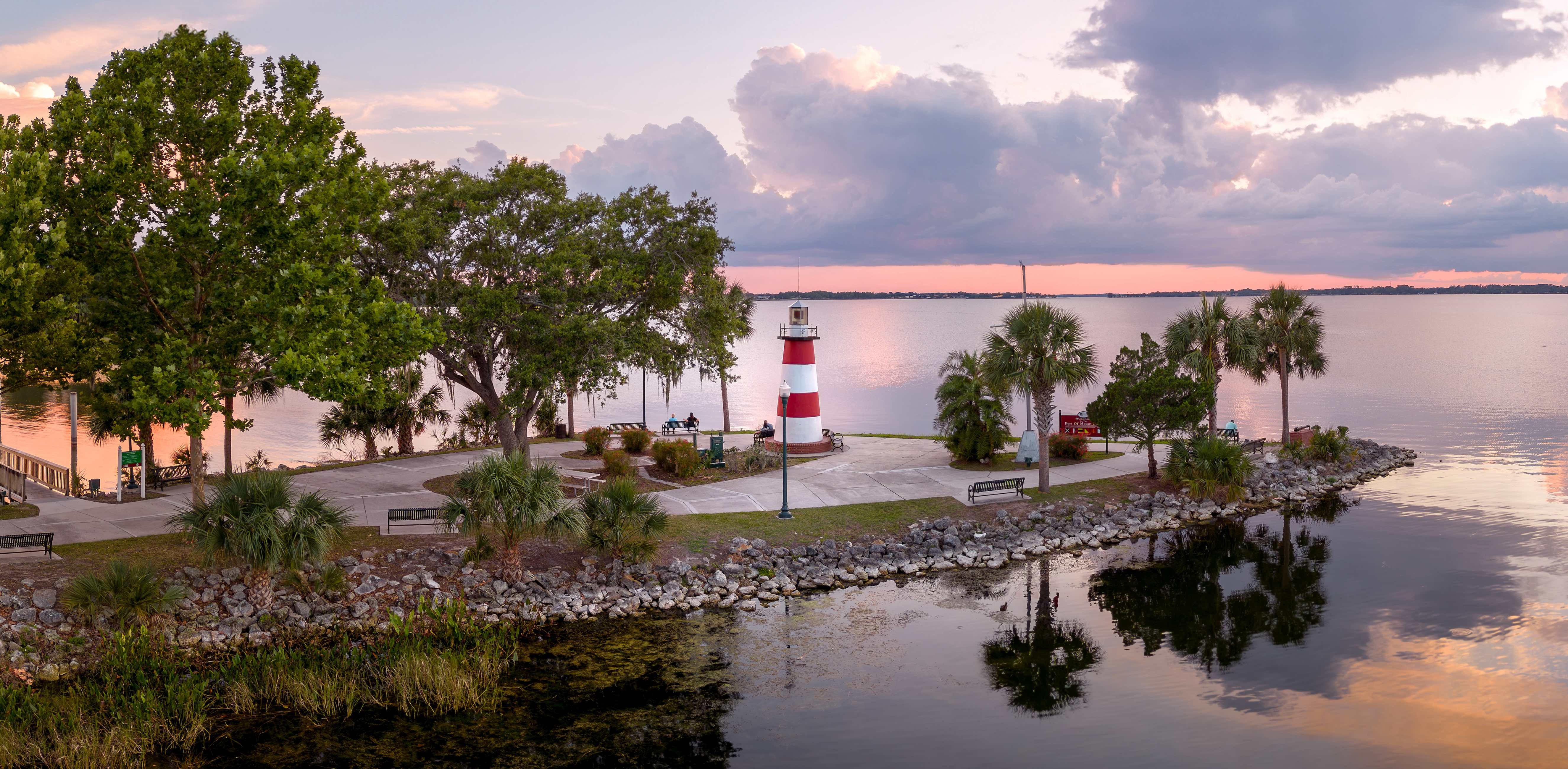 Mount Dora Lighthouse at sunset with palm trees
